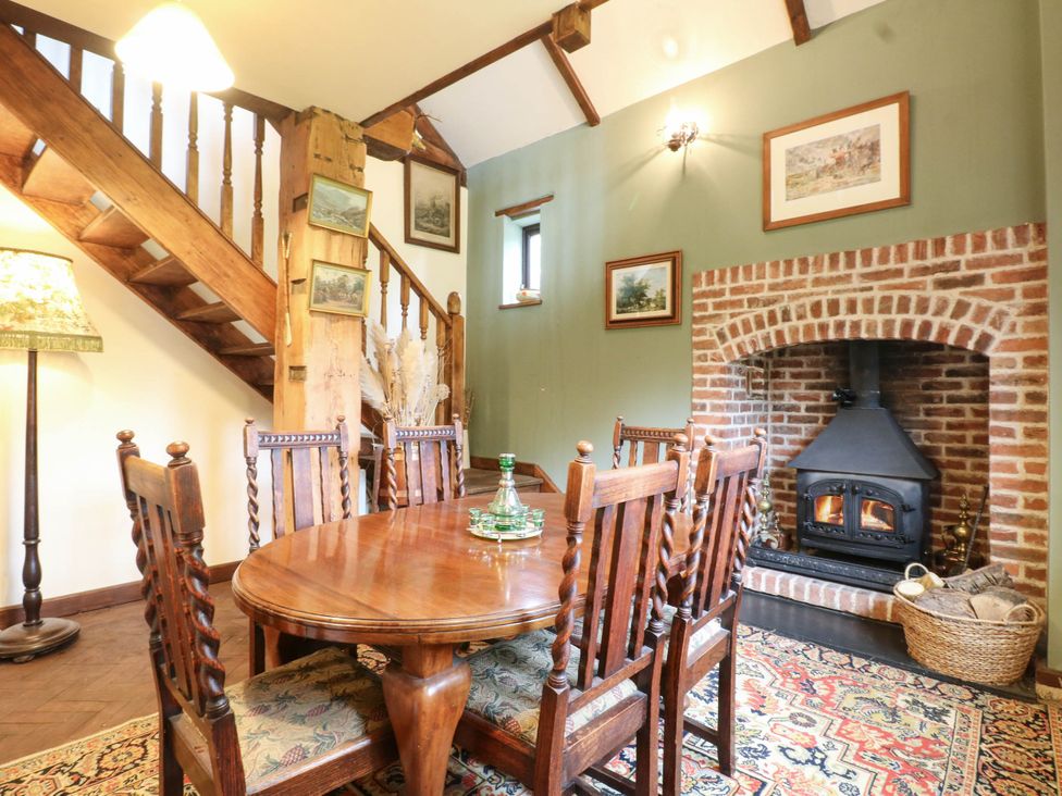 A dining room with a table and chairs at The Barn in Tamworth