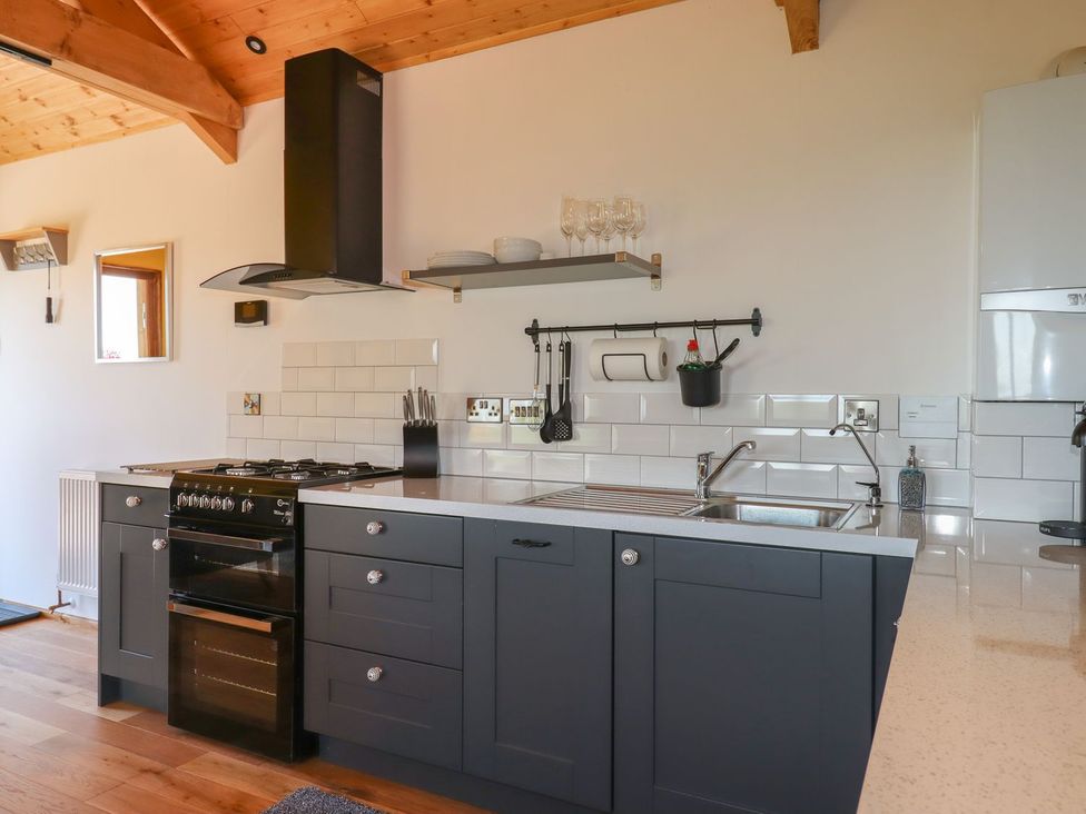 A kitchen with sink and cooker at Nelli Lodge at Mile End in Crediton