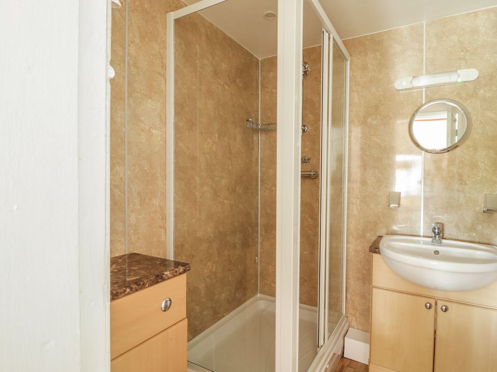 A bathroom with a shower and sink at Cottage 1 in Braithwaite