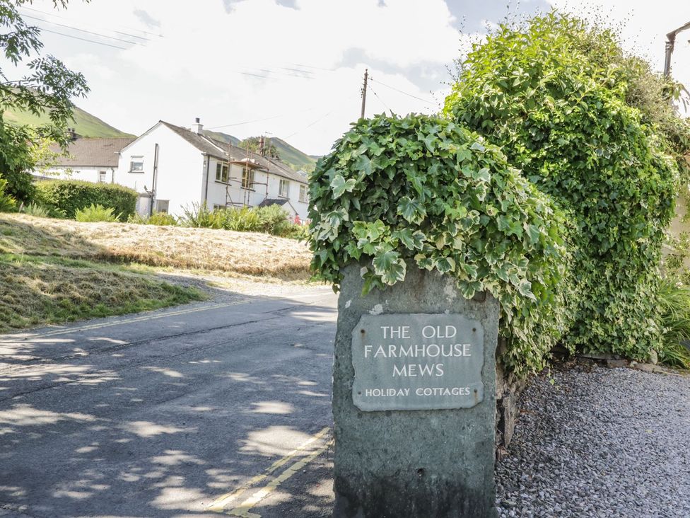 A sign for The Old Farmhouse Mews holiday cottages in Braithwaite