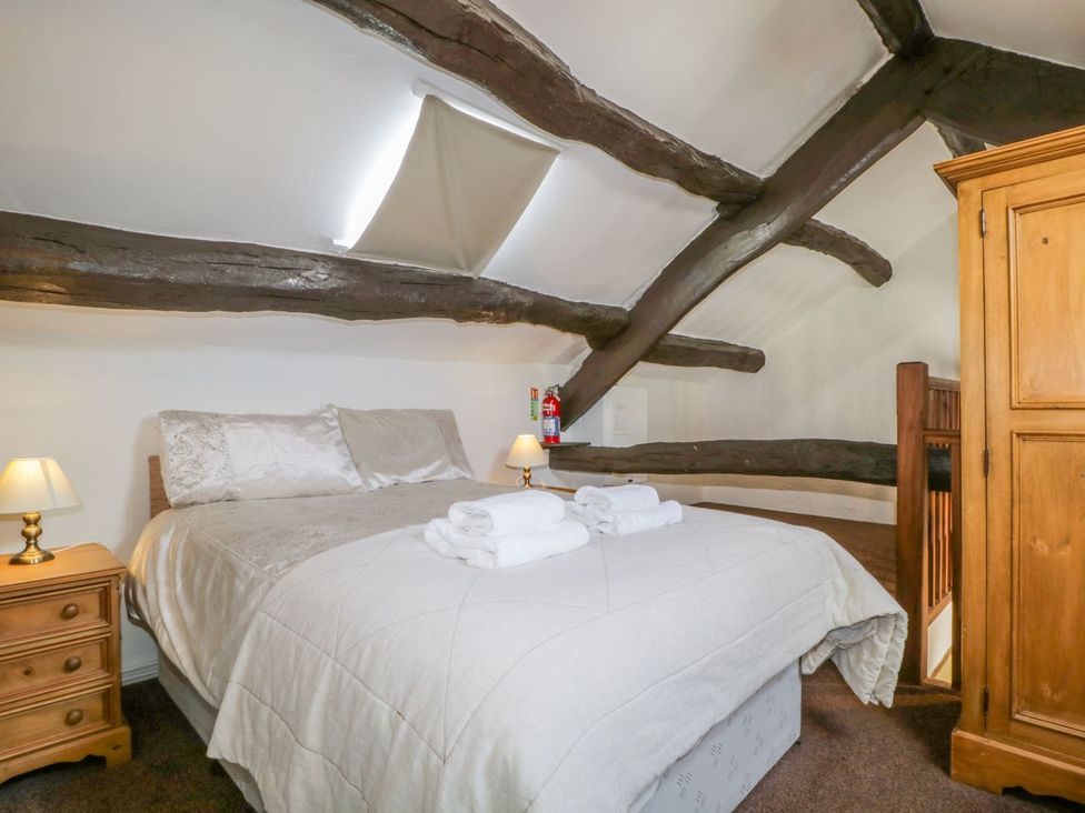 A bedroom with a bed and bedside lamp at Cottage 2 in Keswick
