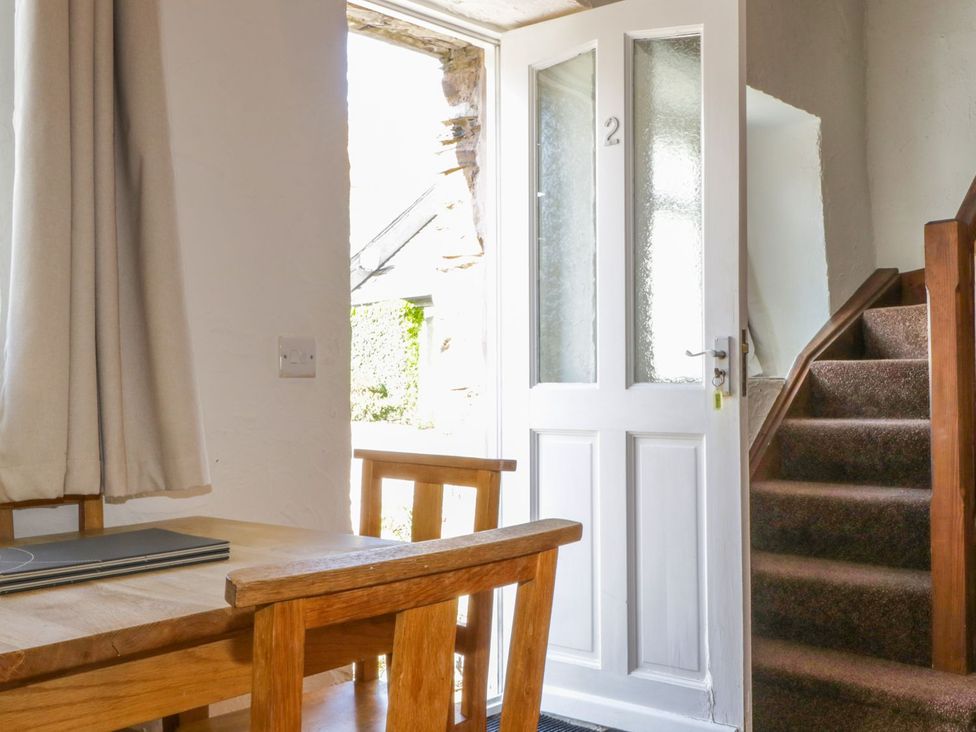 An entryway with a door and a staircase at Cottage 2 in Keswick
