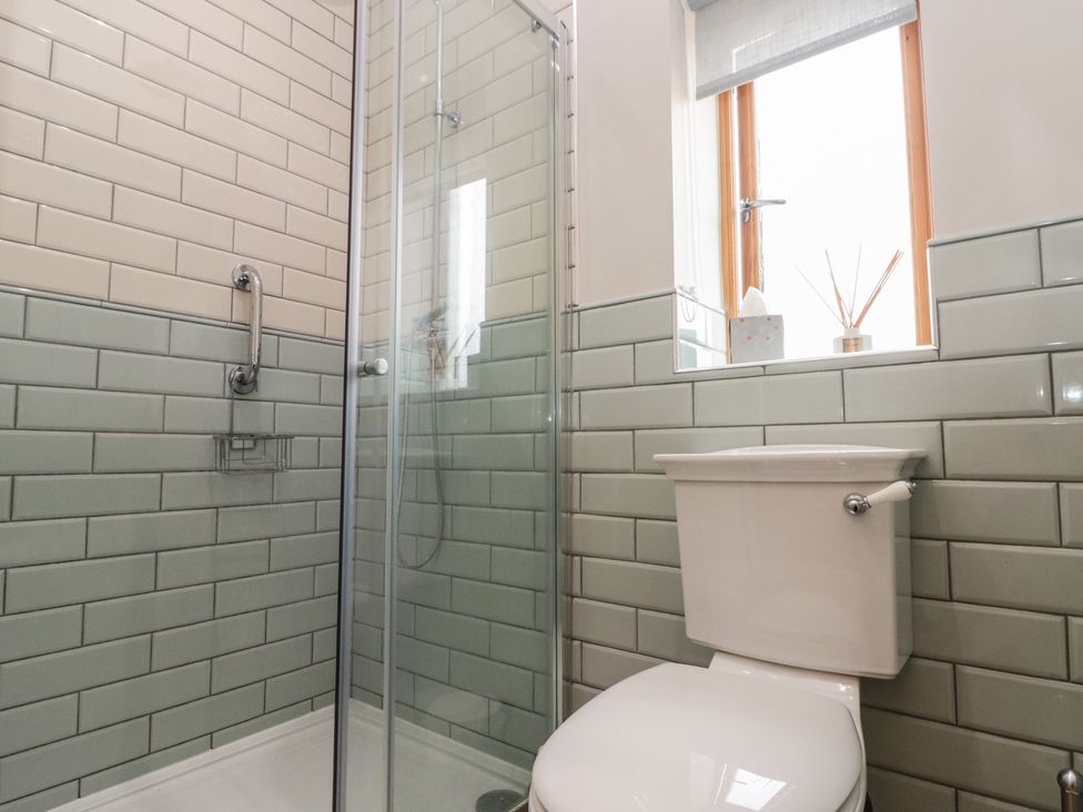 A bathroom with a shower and toilet at Bumble Bee Lodge Filey