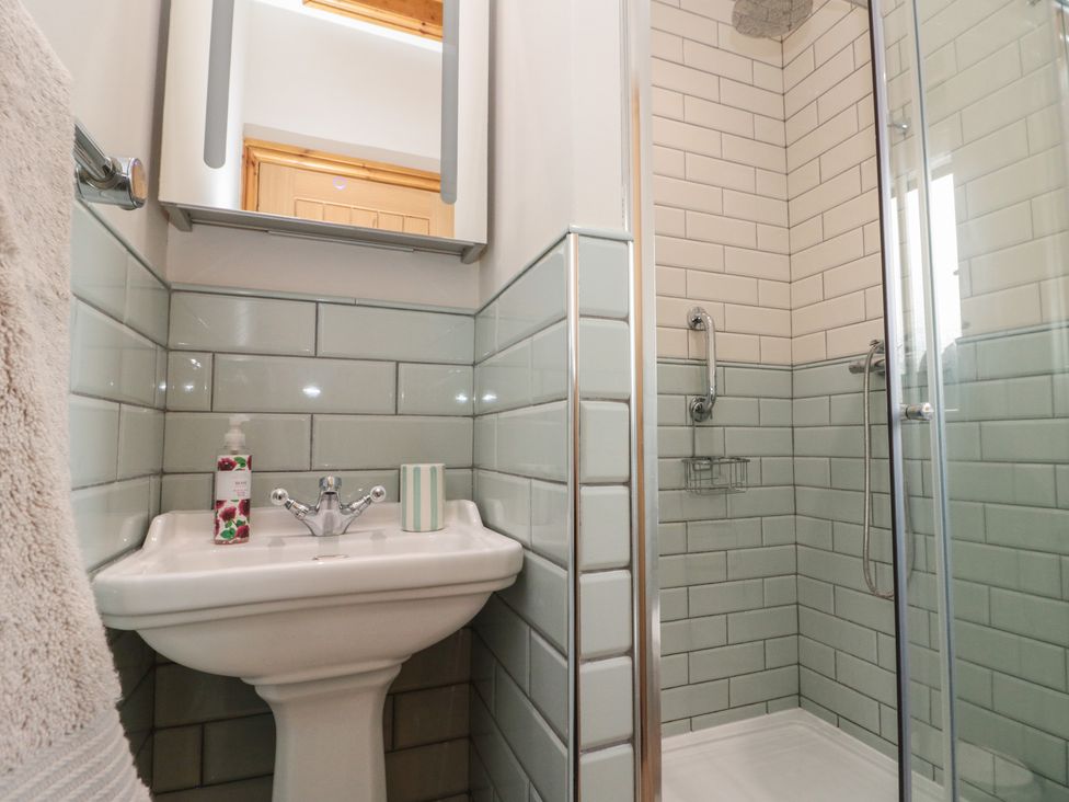 A bathroom with a shower and wash basin at Bumble Bee Lodge in Filey