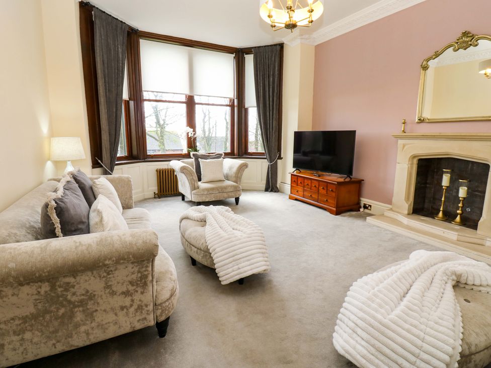 A living room with a sofa and TV at Flaxstead Grange in Newbottle
