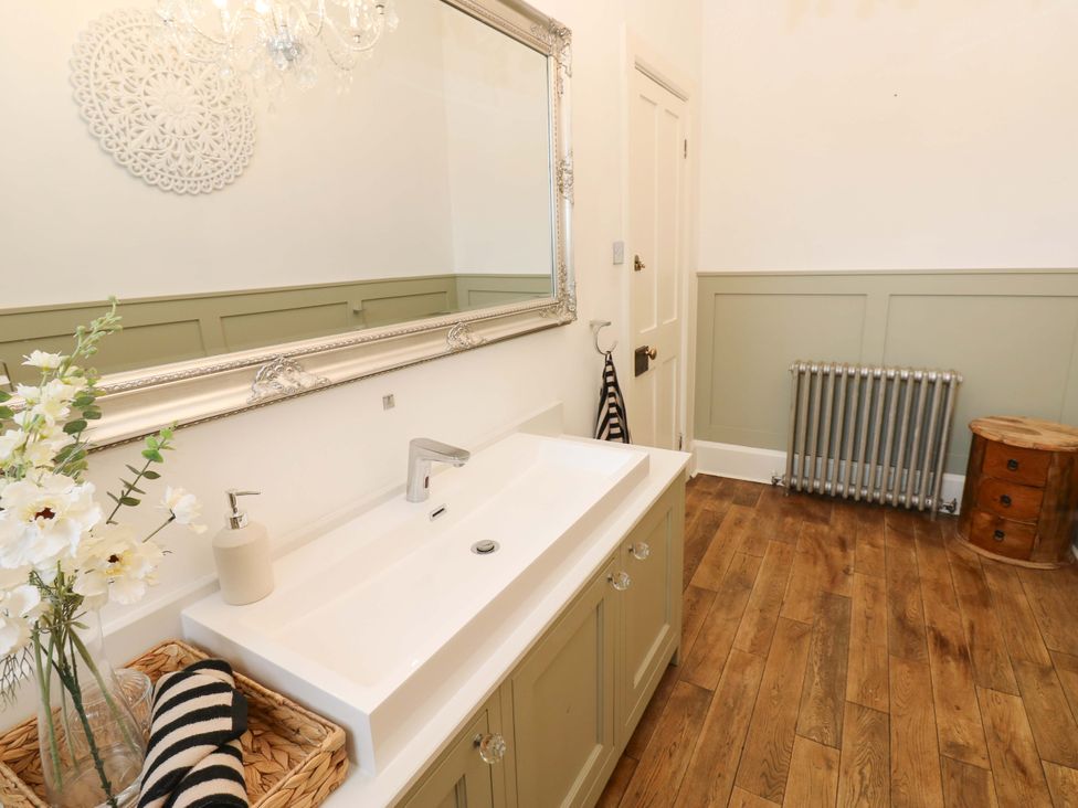 A bathroom with a sink and mirror at Flaxstead Grange in Newbottle