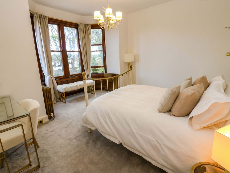 A bedroom with a bed and windows at Flaxstead Grange in Newbottle