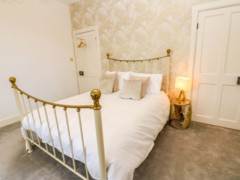 A bedroom with a bed and bedside table at Flaxstead Grange in Newbottle