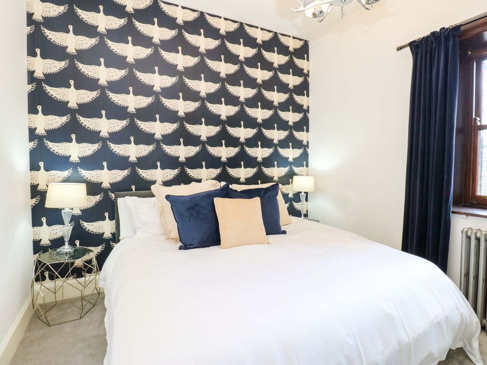 A bedroom with a bed and lamps at Flaxstead Grange in Newbottle