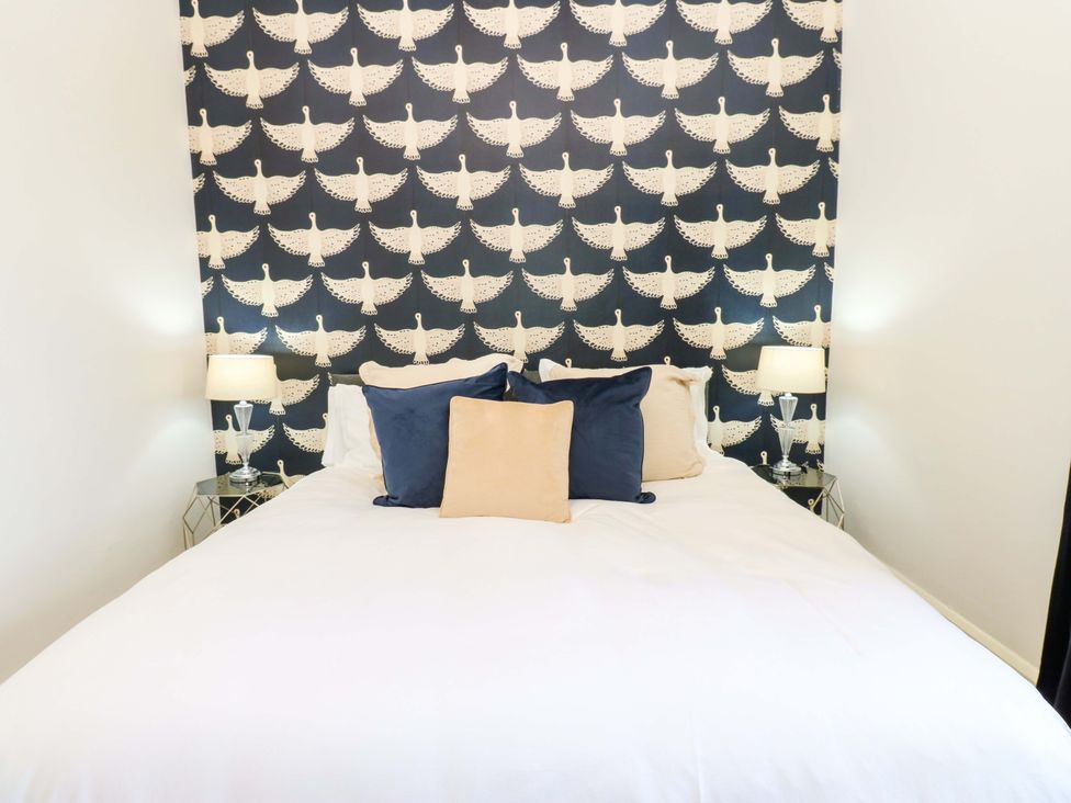A bedroom with a bed and lamps at Flaxstead Grange in Newbottle