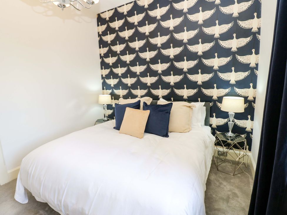 A bedroom with a bed and decorative wallpaper at Flaxstead Grange in Newbottle
