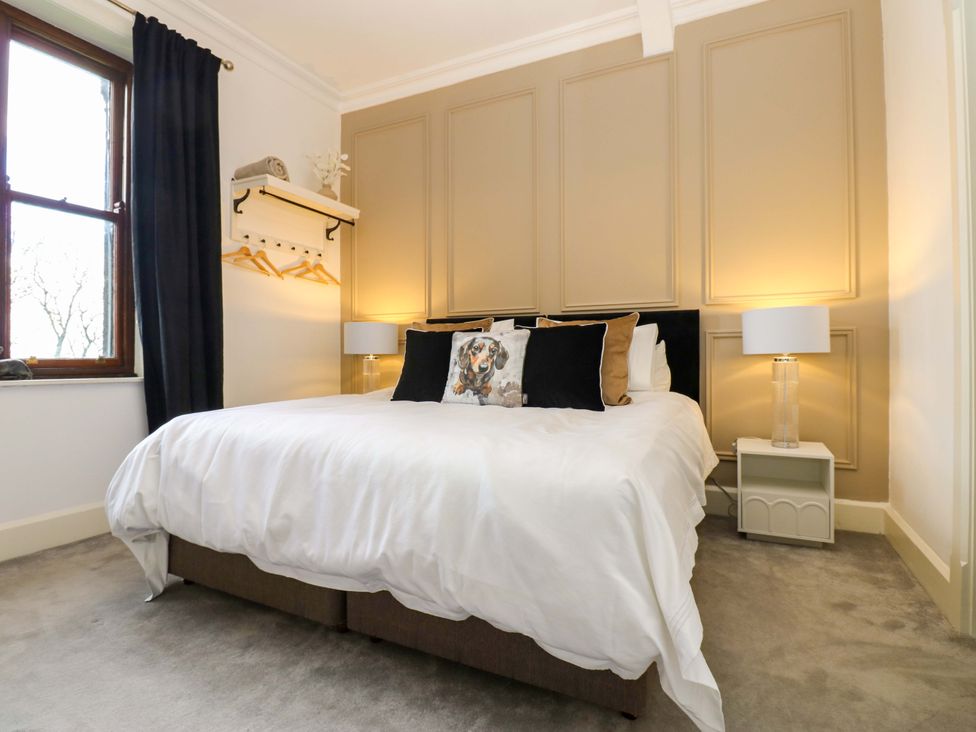 A bedroom with a bed and lamps at Flaxstead Grange in Newbottle