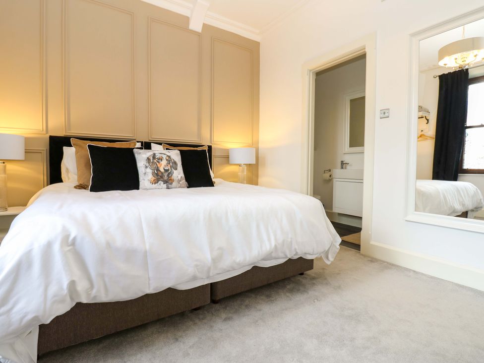 A bedroom with a bed and a door at Flaxstead Grange in Newbottle