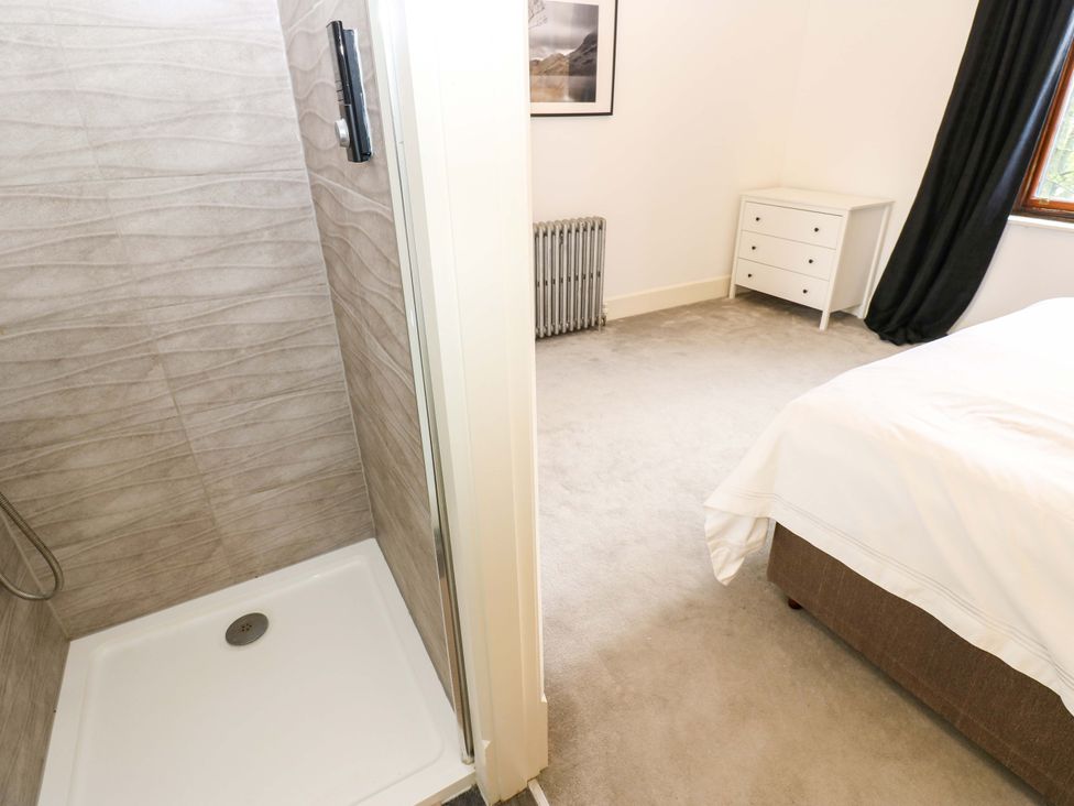 A bedroom with a shower and furniture at Flaxstead Grange in Newbottle
