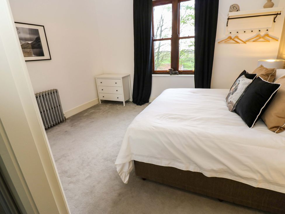 A bedroom with a bed and nightstand at Flaxstead Grange in Newbottle