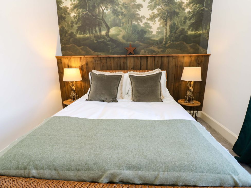 A bedroom with a bed and wall mural at Flaxstead Grange in Newbottle