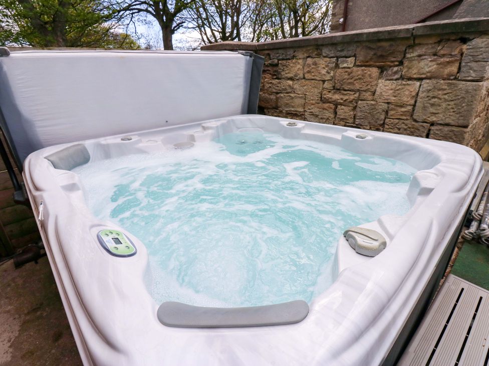 A hot tub filled with water at Flaxstead Grange in Newbottle