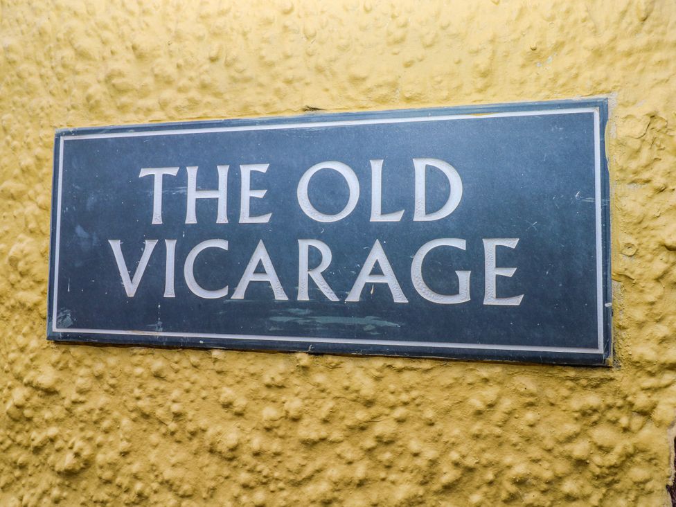 A sign with the name The Old Vicarage