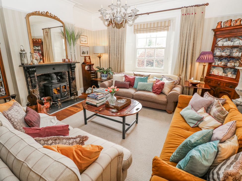 A living room with sofas and a fireplace at The Old Vicarage in Carmarthen