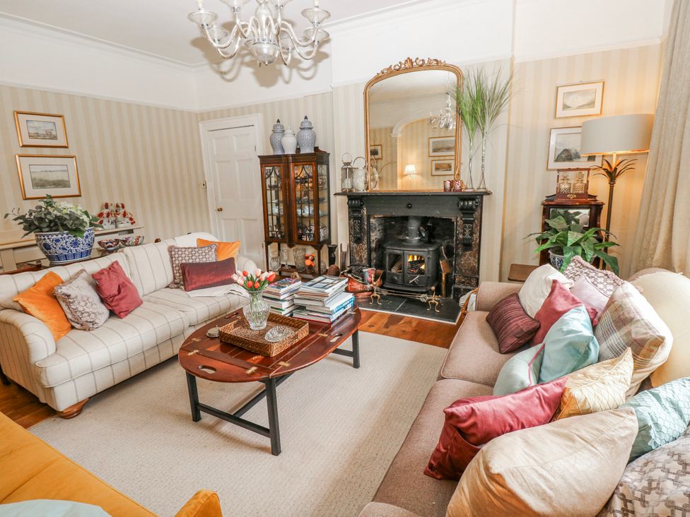 A living room with a fireplace and coffee table at The Old Vicarage in Carmarthen