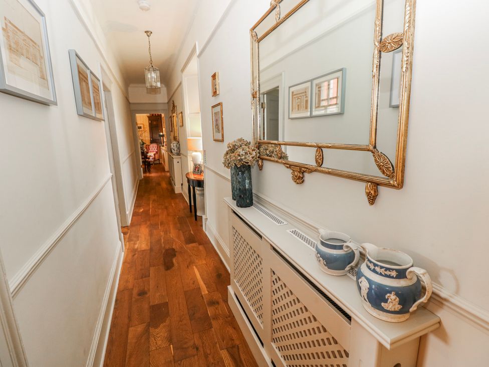 A hallway with a mirror and vases at The Old Vicarage in Carmarthen