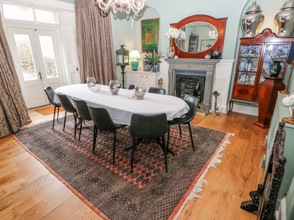 A dining room with a table and chairs at The Old Vicarage in Carmarthen