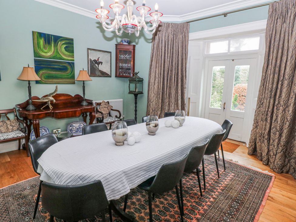 A dining room with a table and chairs at The Old Vicarage in Carmarthen