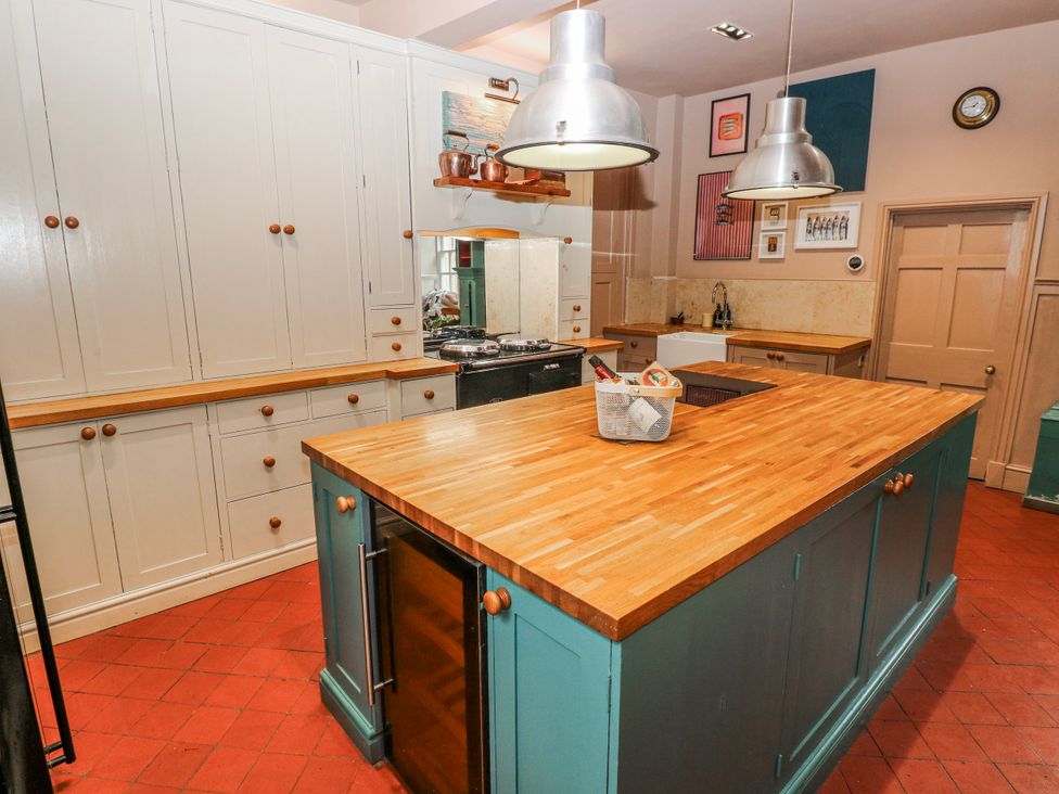 A kitchen with cabinets and an island at The Old Vicarage in Carmarthen