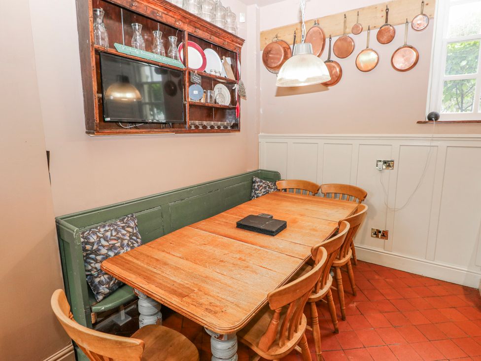 A dining room with a table and chairs at The Old Vicarage in Carmarthen