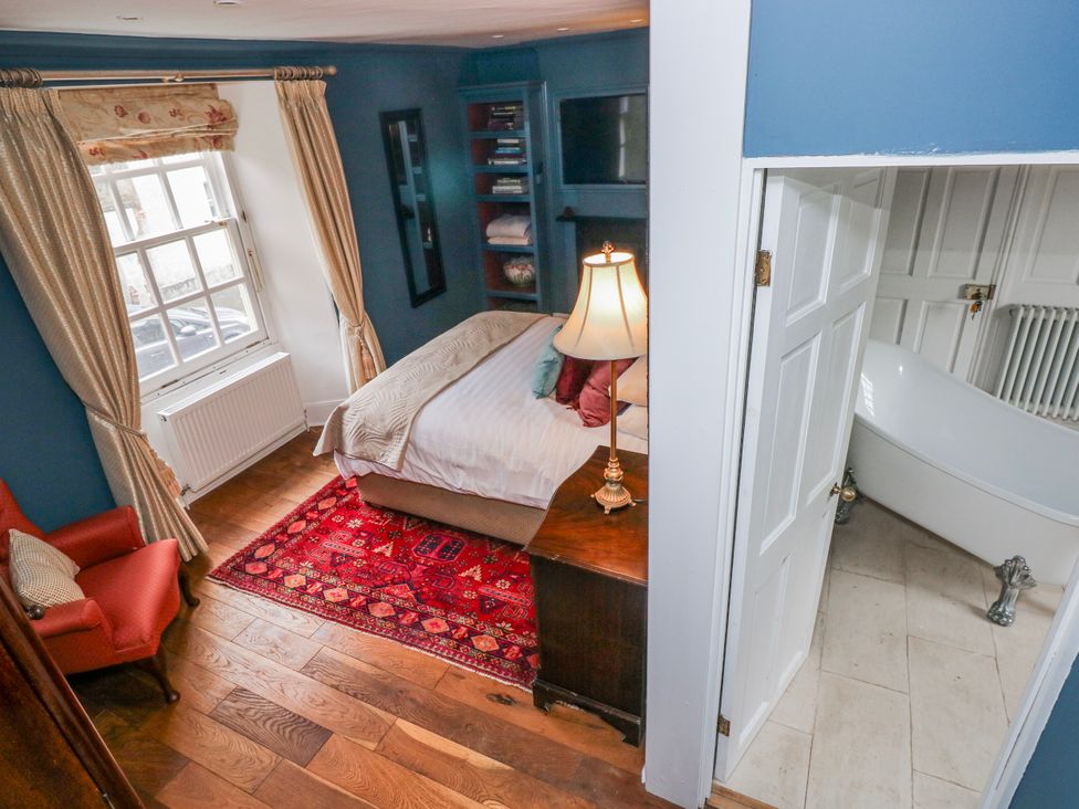 A bedroom with a bed and lamp at The Old Vicarage in Carmarthen
