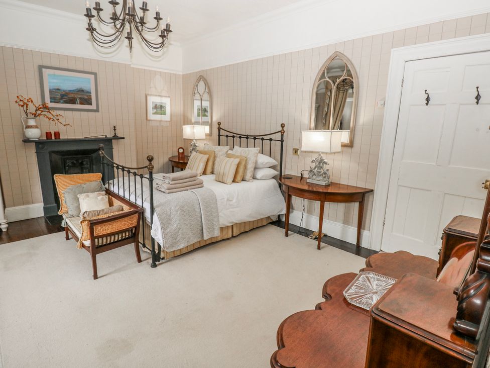 A bedroom with a bed and nightstand at The Old Vicarage in Carmarthen