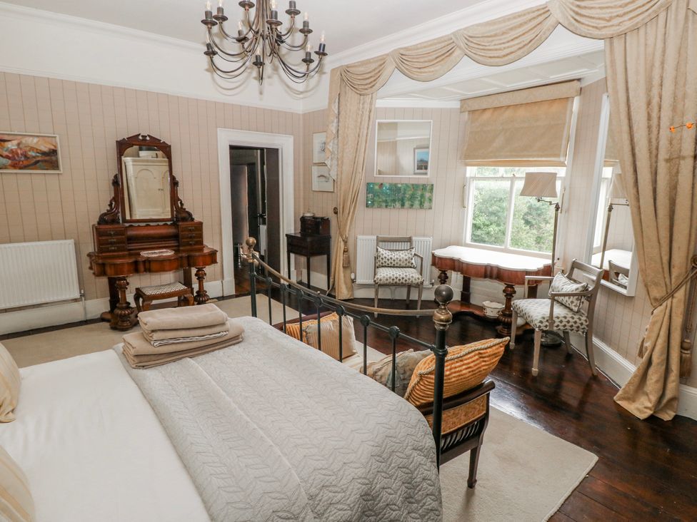 A bedroom featuring a bed and furniture at The Old Vicarage in Carmarthen
