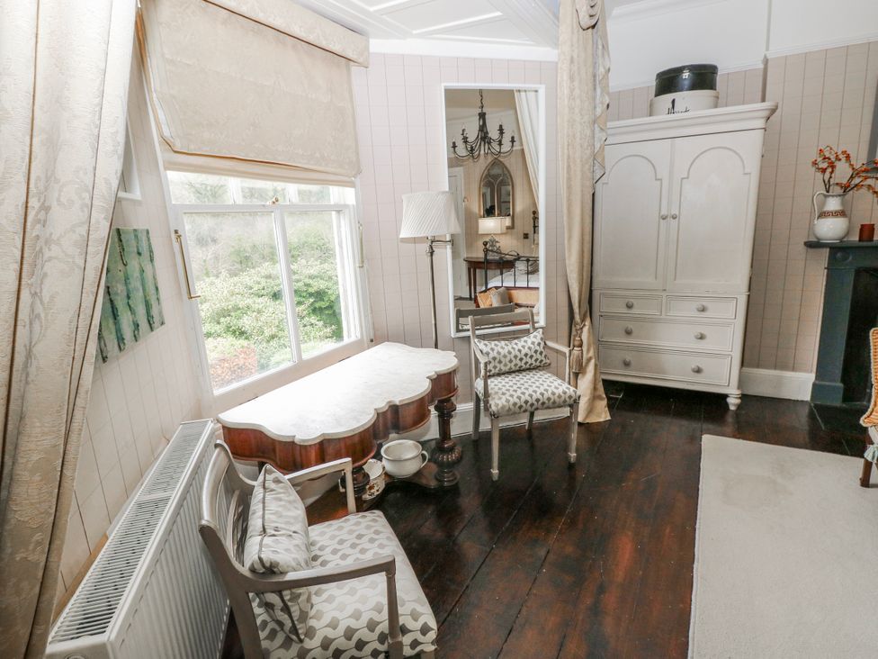 A living room with furniture and a window at The Old Vicarage in Carmarthen