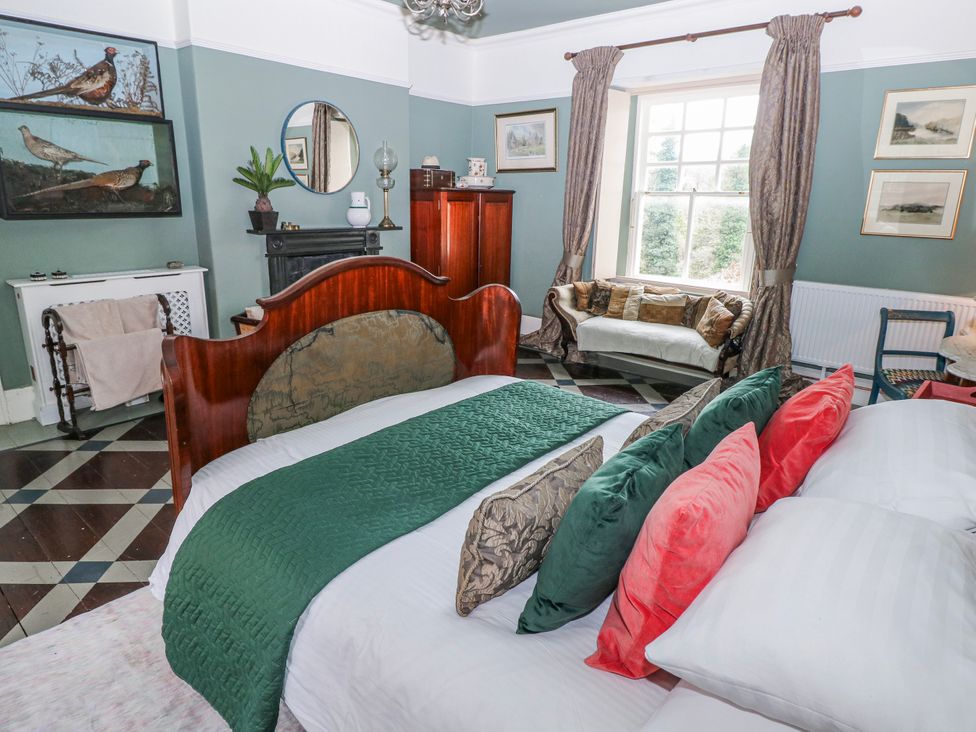 A bedroom with a bed and a sofa at The Old Vicarage in Carmarthen