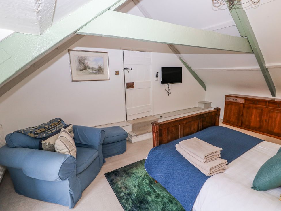 A bedroom with a bed and TV at The Old Vicarage in Carmarthen