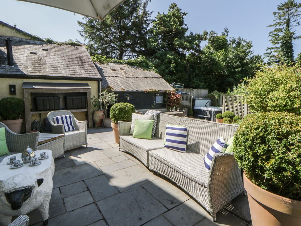 An outdoor area with seating and a table at The Old Vicarage in Laugharne