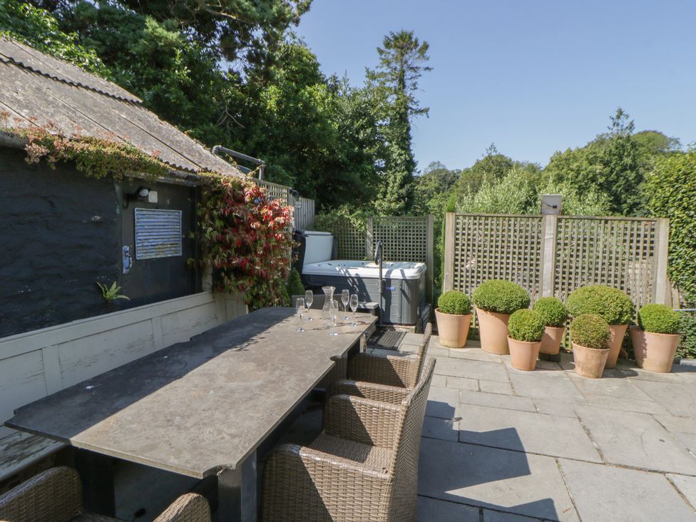 An outdoor area with a table and chairs at The Old Vicarage in Laugharne