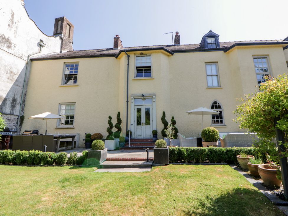 The exterior of a house with garden seating area at The Old Vicarage in Laugharne