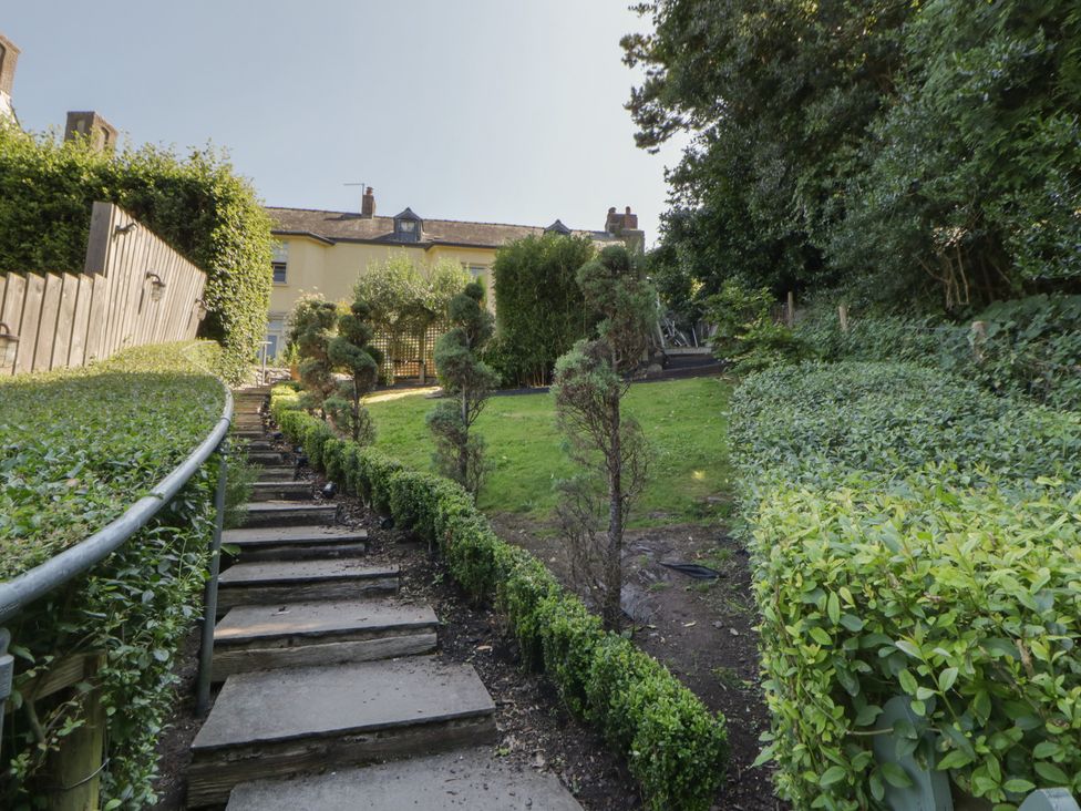 A garden with stairs leading up to a building at The Old Vicarage in Laugharne