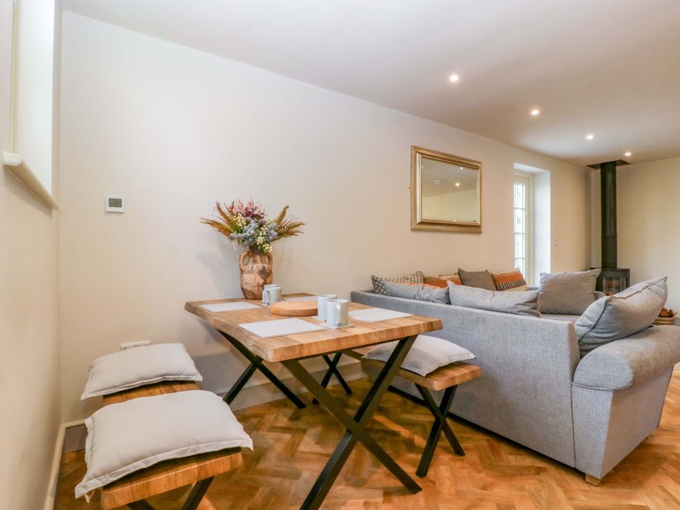 A living room with a table and chairs alongside a couch at Broadmoor Chapel Hereford
