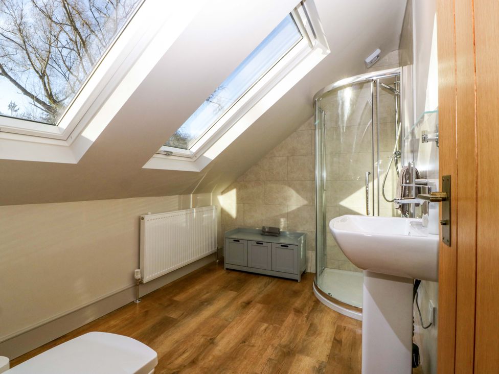 A bathroom with a shower, sink, and toilet at Broadmoor Chapel, Hereford