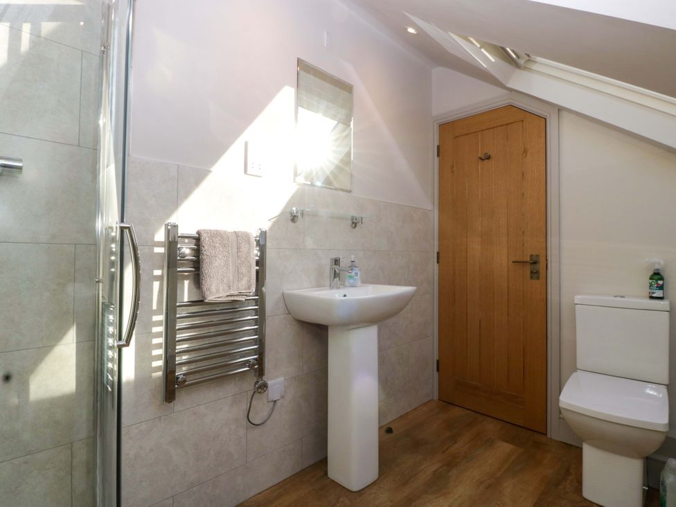 A bathroom with a shower, sink, and toilet at Broadmoor Chapel in Hereford