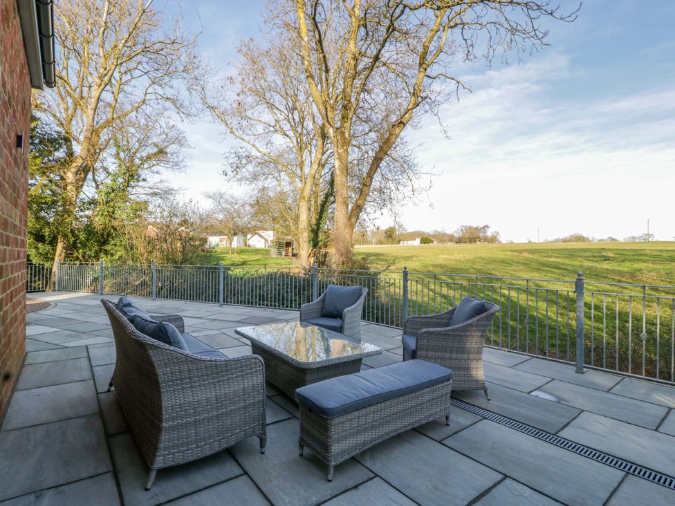 An outdoor seating area with a table and chairs at Broadmoor Chapel in Hereford