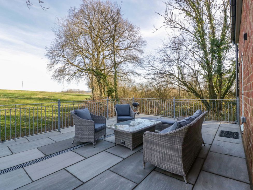 An outdoor patio with seating and a table at Broadmoor Chapel in Hereford
