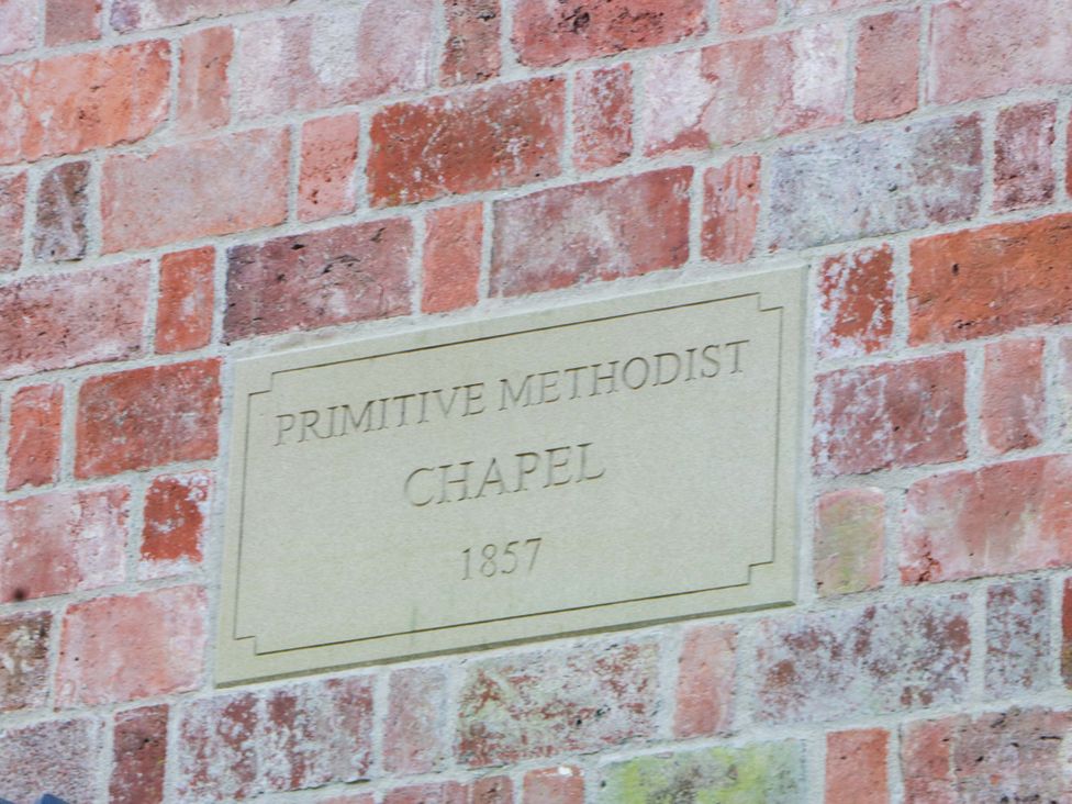 A plaque on a brick wall indicating Primitive Methodist Chapel 1857 at Broadmoor Chapel in Hereford