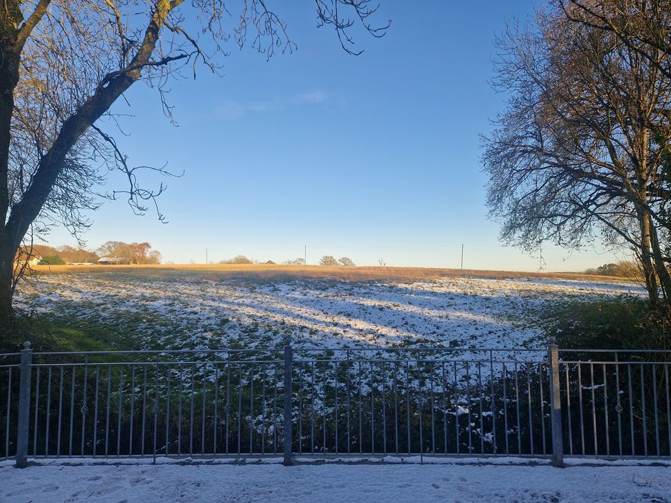 A field with snow and a fence at Broadmoor Chapel in Hereford
