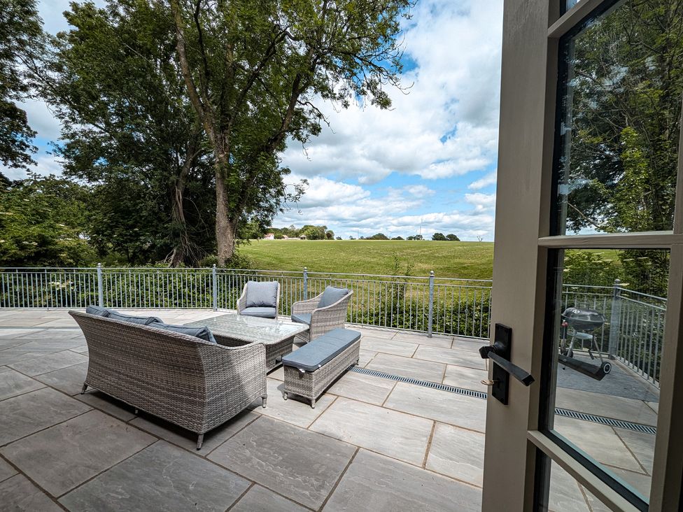 An outdoor seating area with views of grass at Broadmoor Chapel Hereford