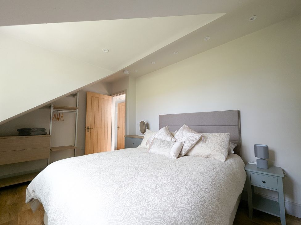 A bedroom with a bed and a closet at Broadmoor Chapel Hereford