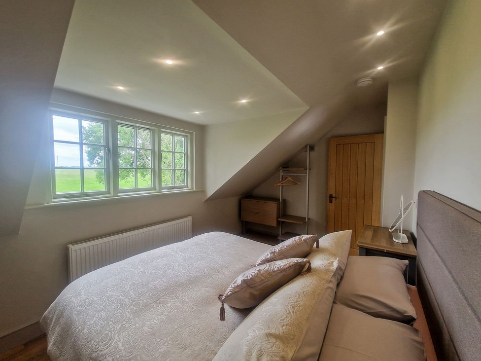 A bedroom with a bed and window at Broadmoor Chapel Hereford