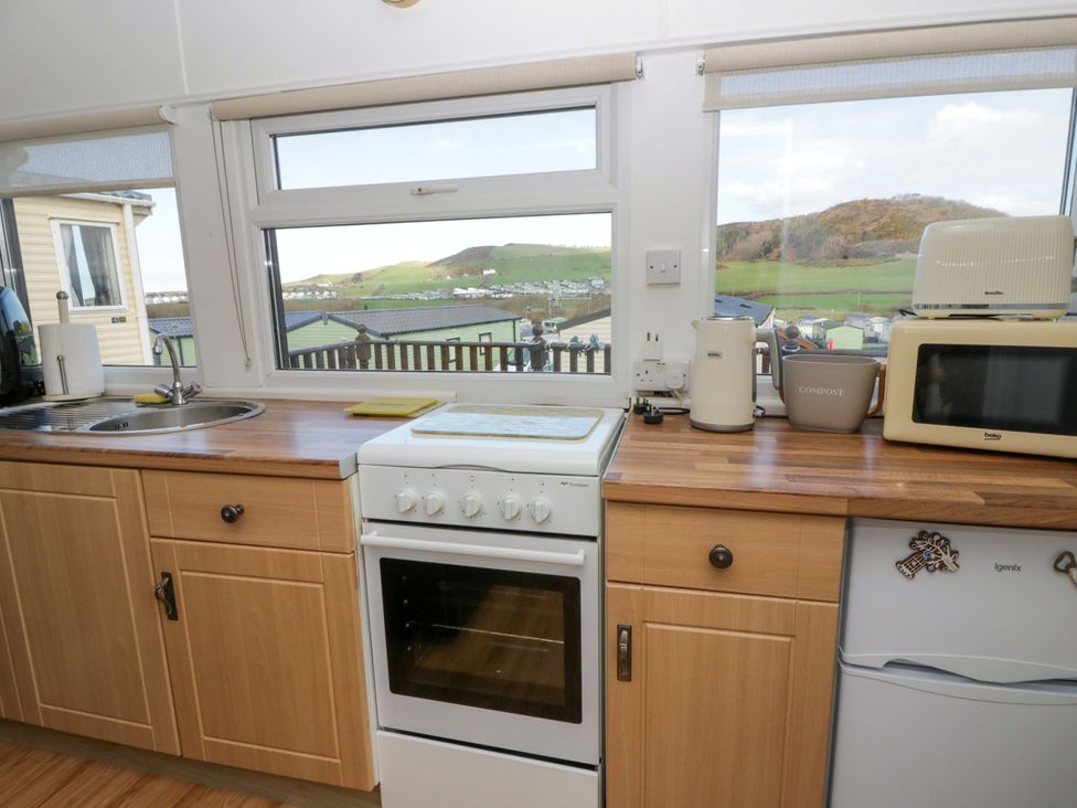 A kitchen with an oven and sink at The Cosy Den in Clarach near Aberystwyth